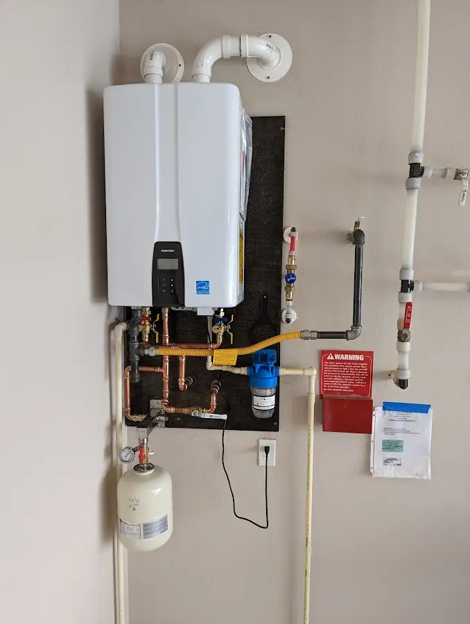 Professional plumber installing copper piping in a Olney home